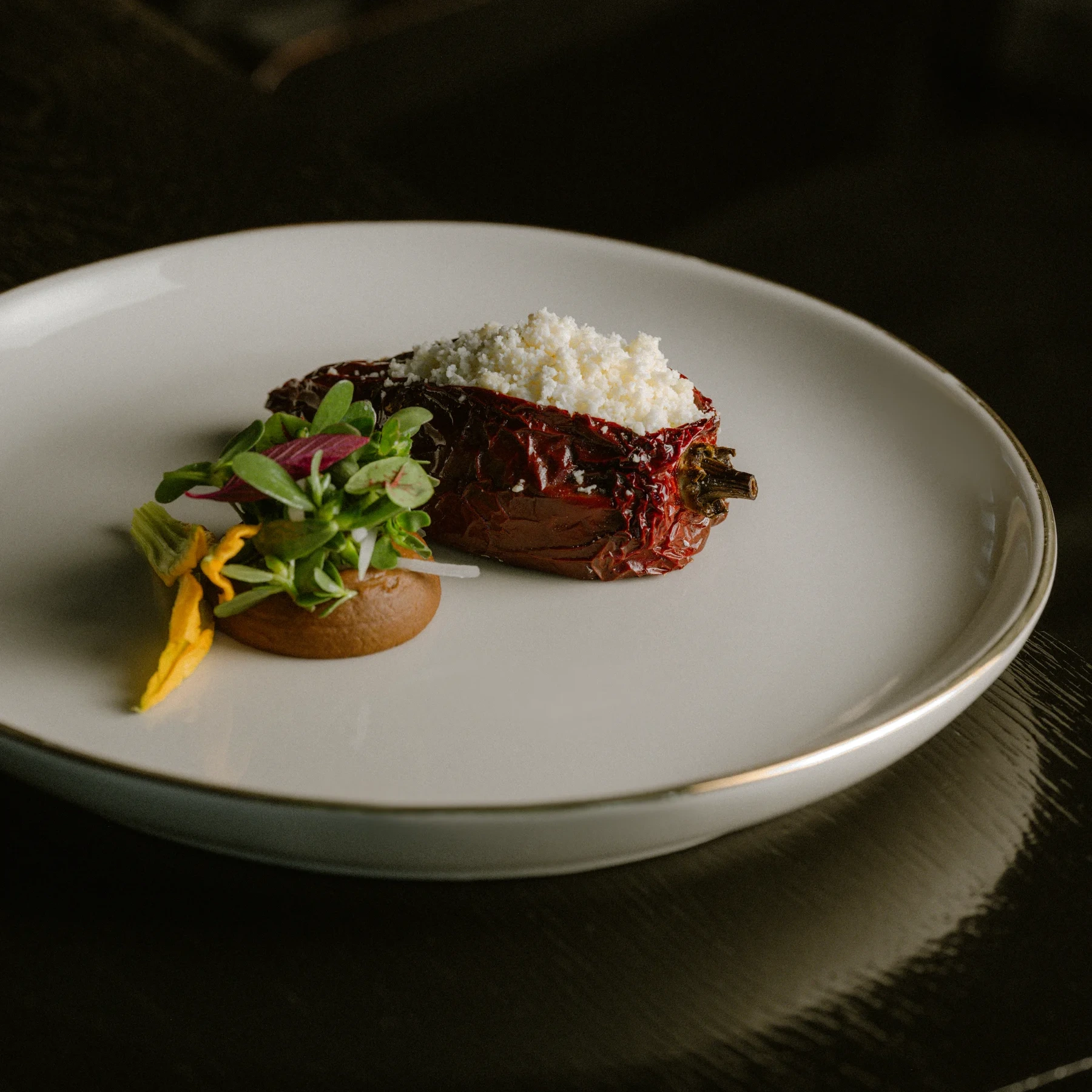 A stuffed ancho chile with fresh cheese and greens.